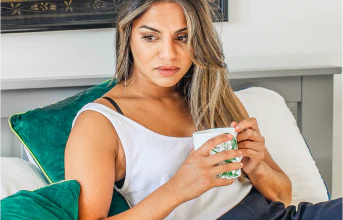 Woman sitting on a sofa with a mug